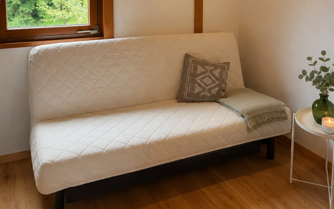 Zimmer mit Schlafcouch und Beistelltisch